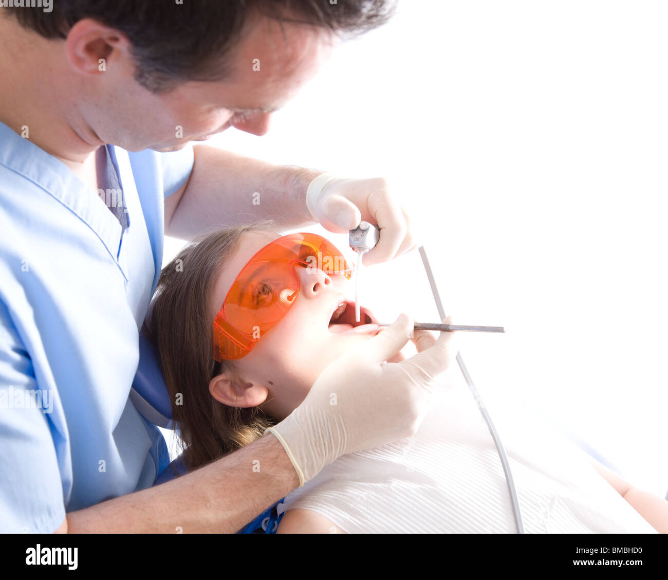 Dentist with patient in dentist chair having teeth cleaning Stock Photo