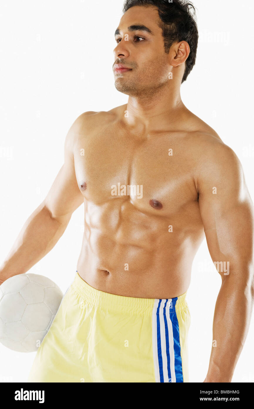 Man holding soccer ball Stock Photo - Alamy