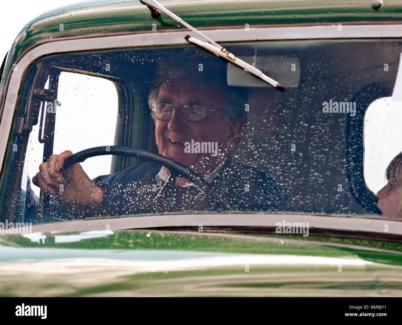 old man driving and old truck close up Stock Photo