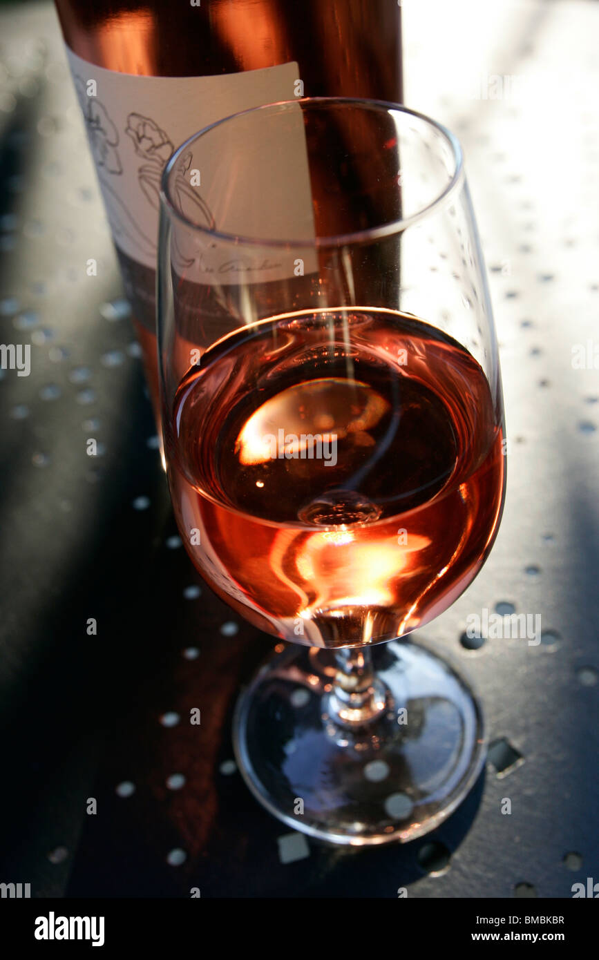 Reflection of a glass of rosé wine with the bottle Stock Photo