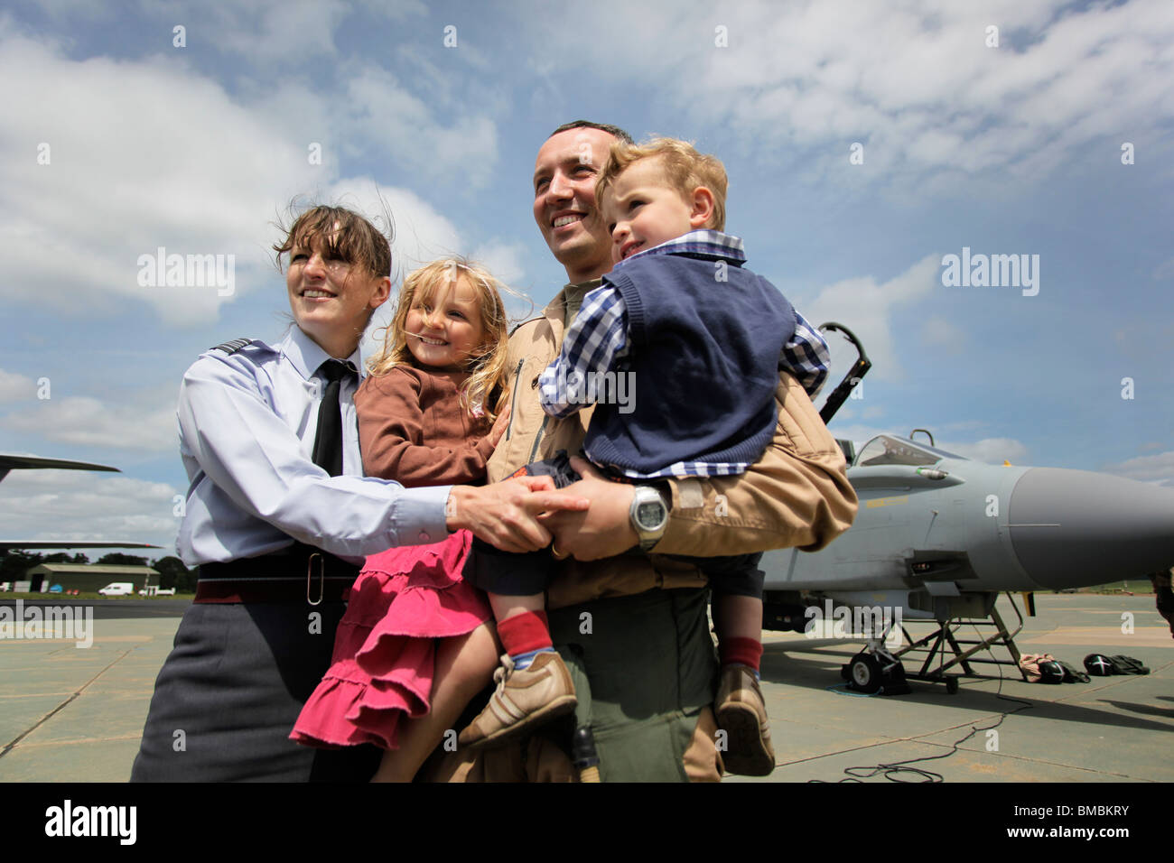 Sqn Ldr Nathan Giles, Holly Giles, Edward Giles & wife Sqn Ldr Anne Giles pose together after being reunited at RAF Marham. Stock Photo