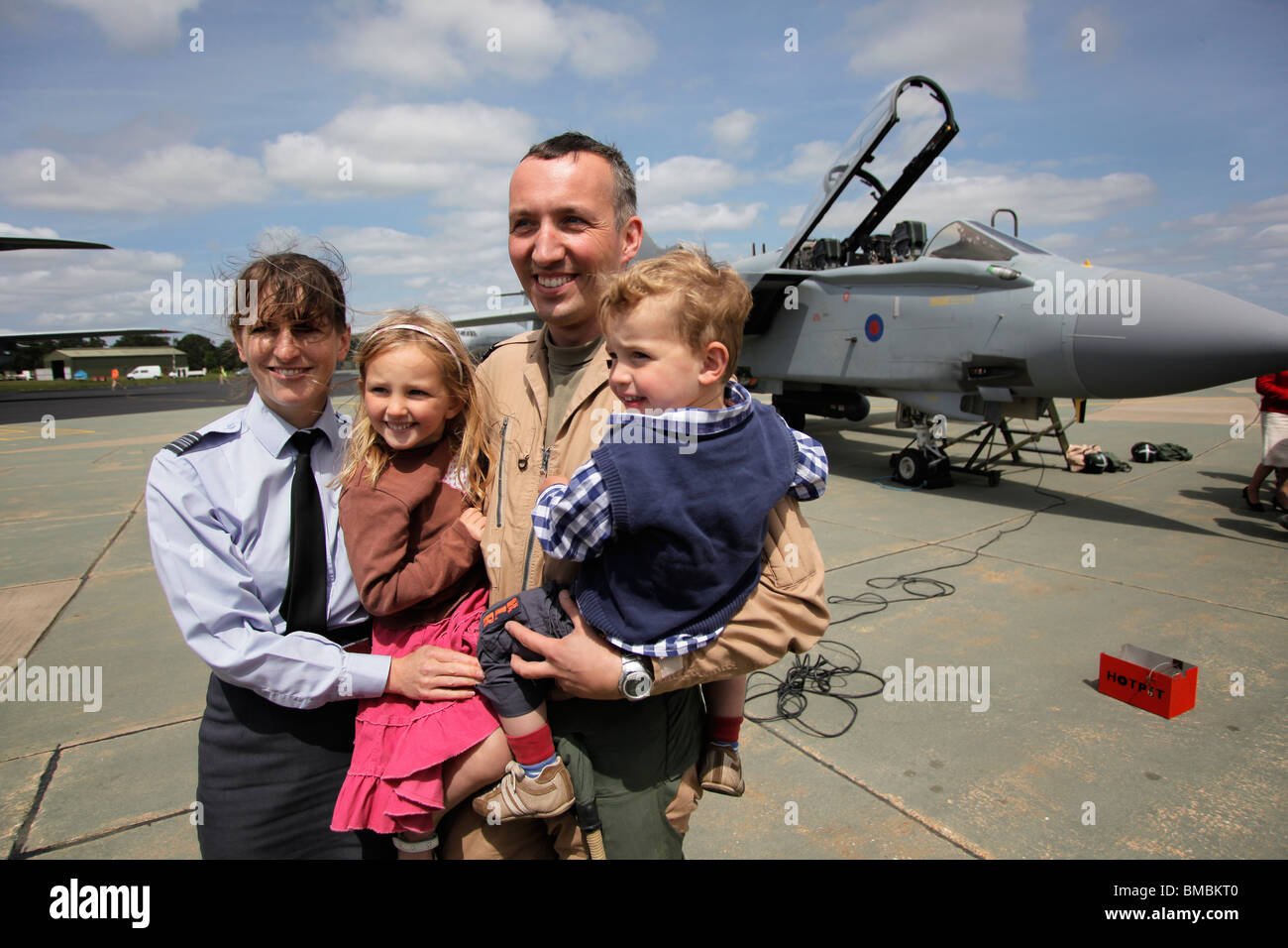 Sqn Ldr Nathan Giles, Holly Giles, Edward Giles & wife Sqn Ldr Anne Giles pose together after being reunited at RAF Marham. Stock Photo