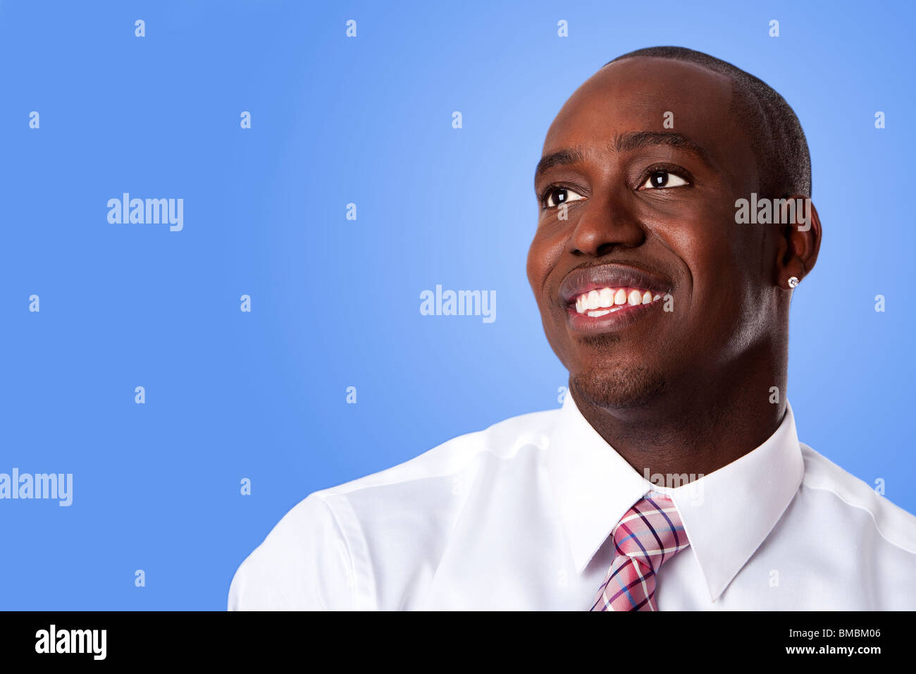 Face of handsome happy African American corporate business man smiling, wearing white shirt and pink with stripes necktie. Stock Photo