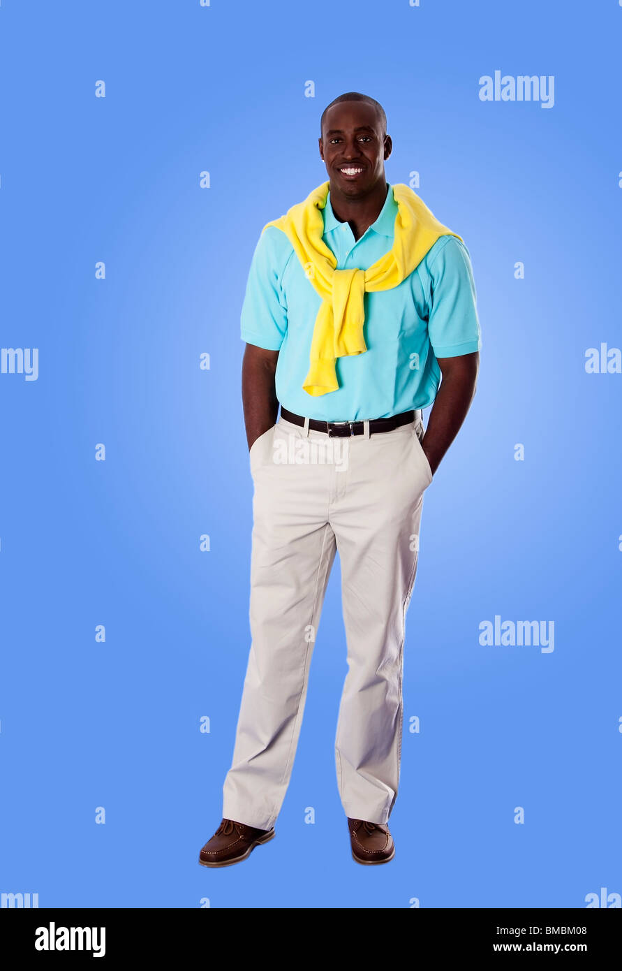 Handsome happy African American corporate business man smiling, standing with hands in pocket, wearing blue shirt. Stock Photo