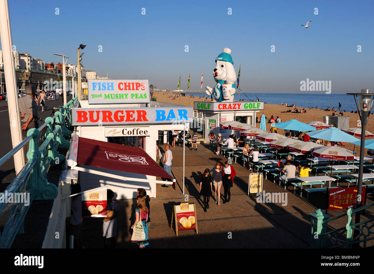 Crazy Golf and Food kiosks including giant slush puppy dog sign on Brighton seafront UK Stock Photo