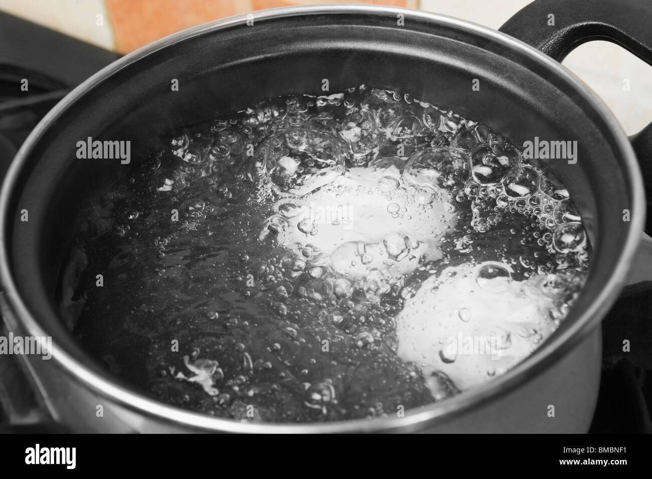 Eggs in the boiling water Stock Photo Alamy
