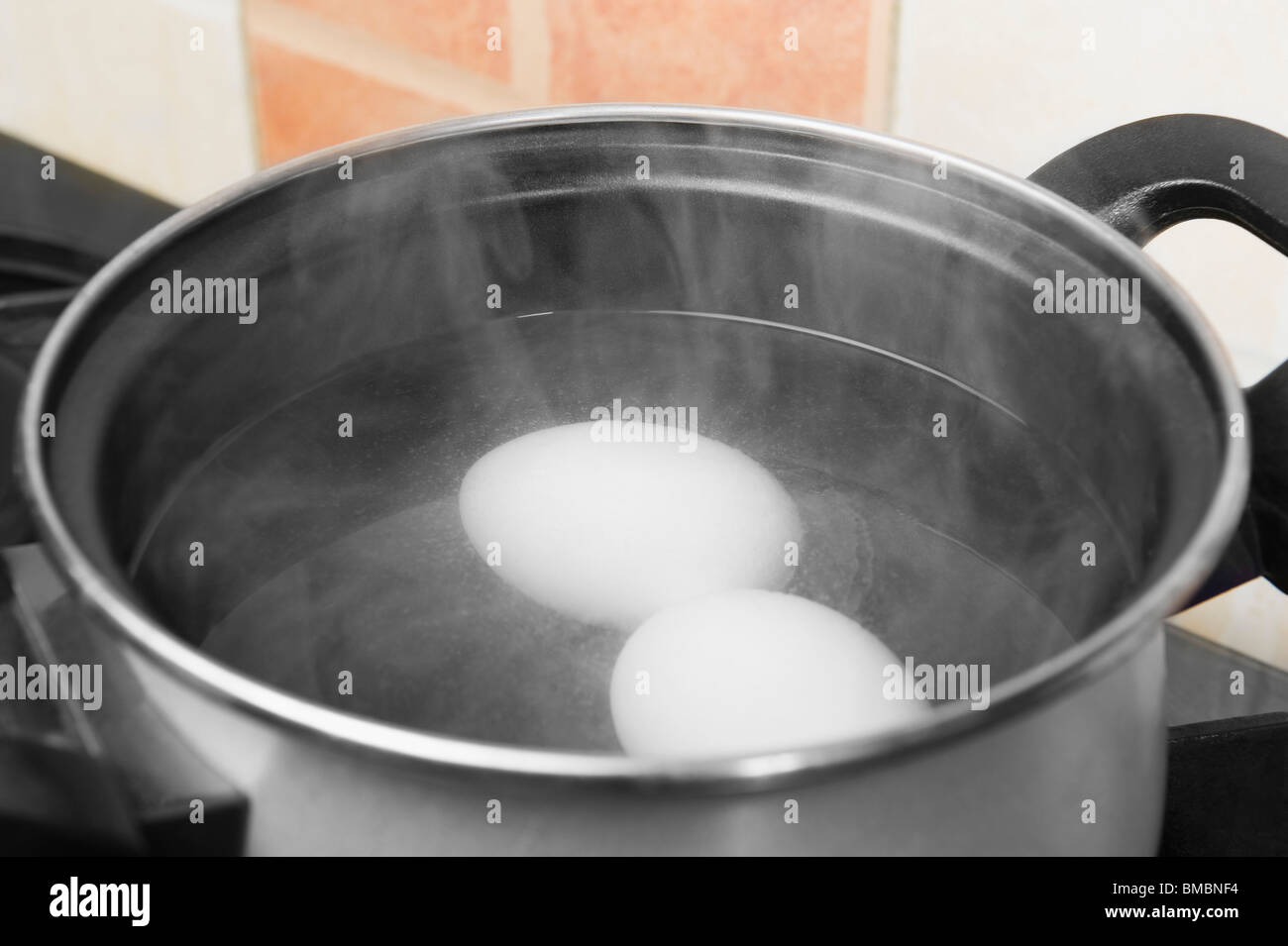 Eggs in the boiling water Stock Photo Alamy