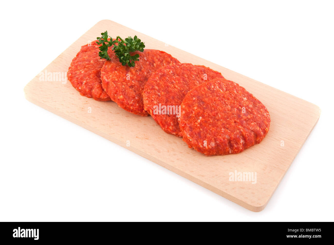 Raw hamburgers with parsley on wooden tray Stock Photo