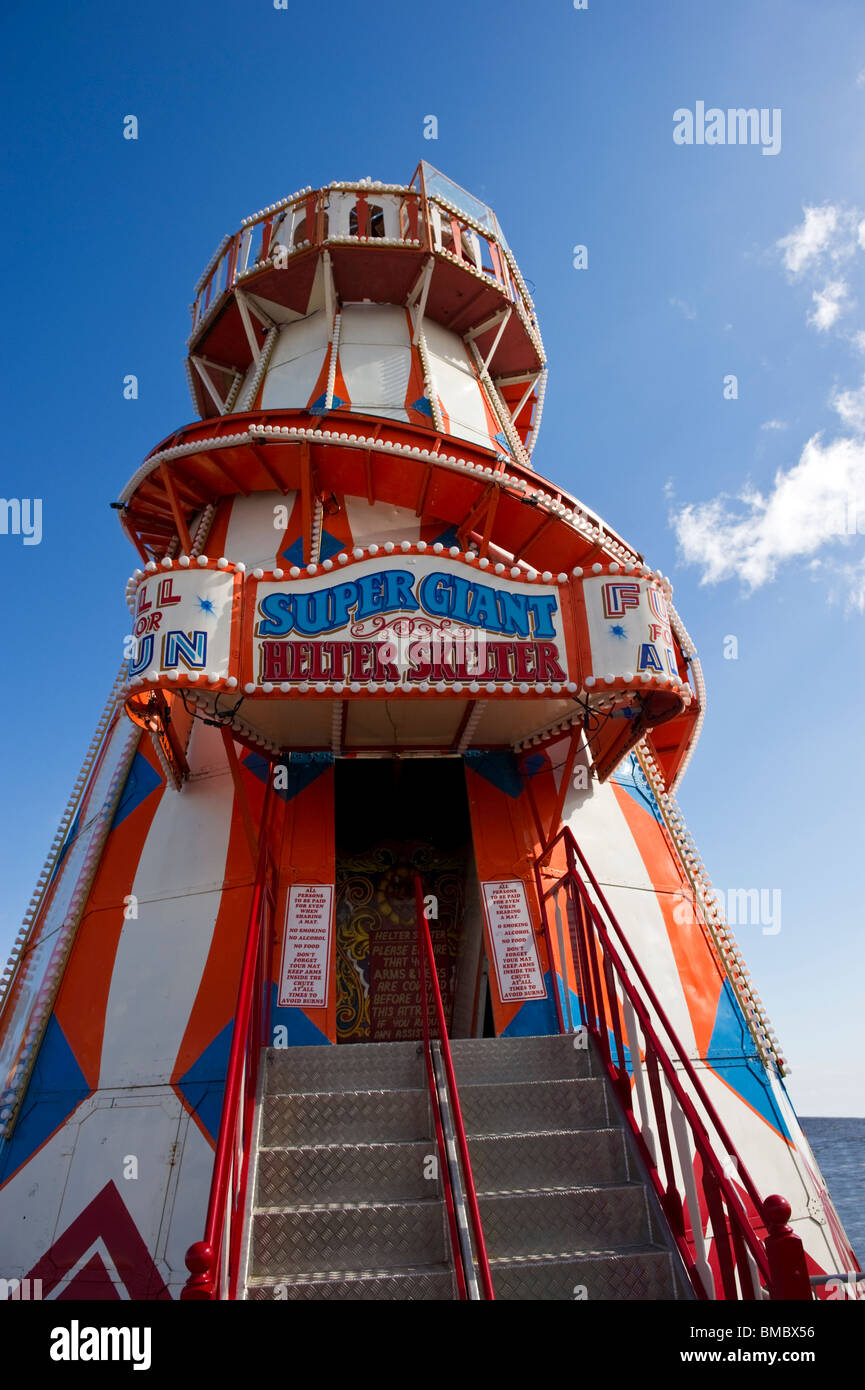 A helter skelter is a traditional fairground amusement, fun and entertainment ride on Clacton pier Essex. Stock Photo