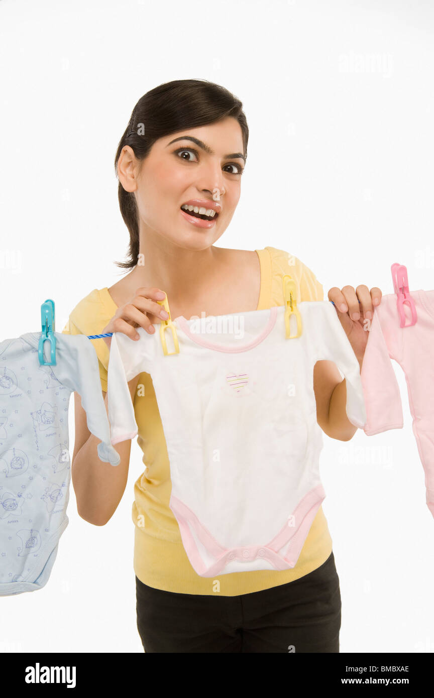 Woman hanging clothes on a clothesline Stock Photo Alamy