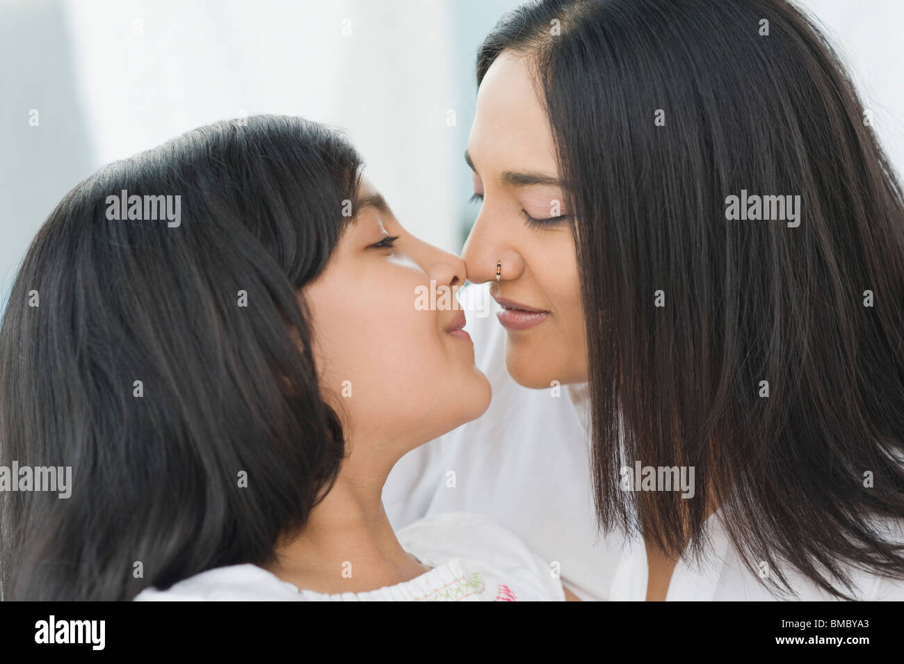 Woman rubbing noses with her daughter Stock Photo Alamy