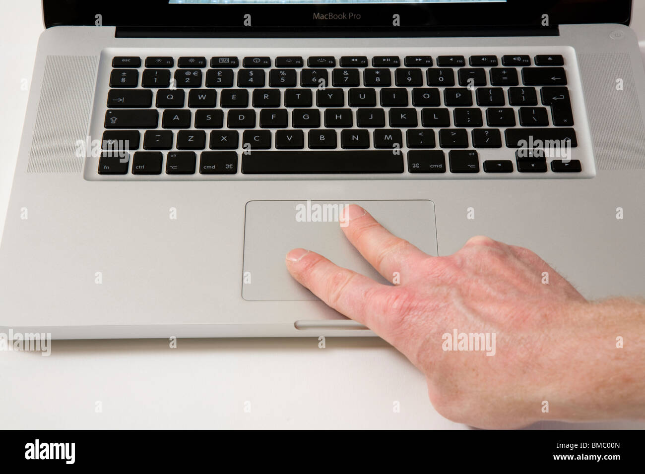 Fingers moving across an Apple Macbook Pro iBook Scrolling TrackPad