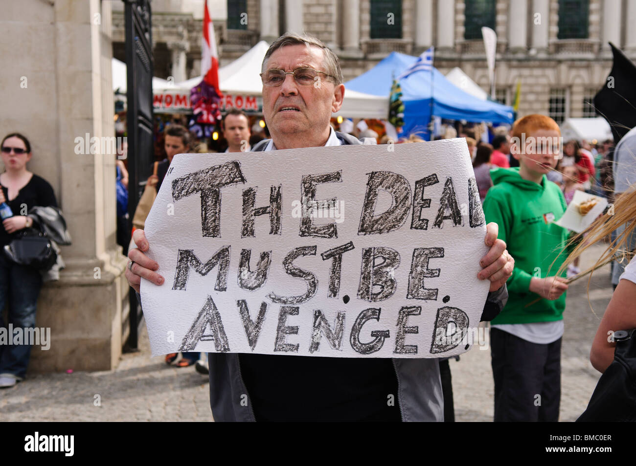 Man holds a homemade sign 'The Dead must be avenged' Stock Photo