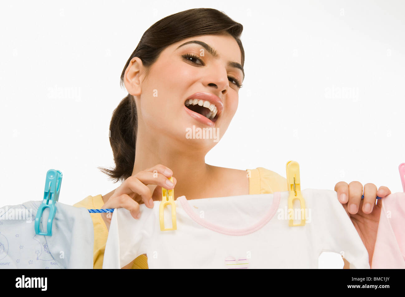 Woman hanging clothes on a clothesline Stock Photo Alamy