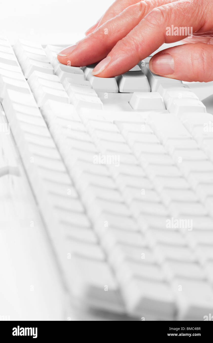 Worker typing on computer keyboard entering data focus on keyboard ...