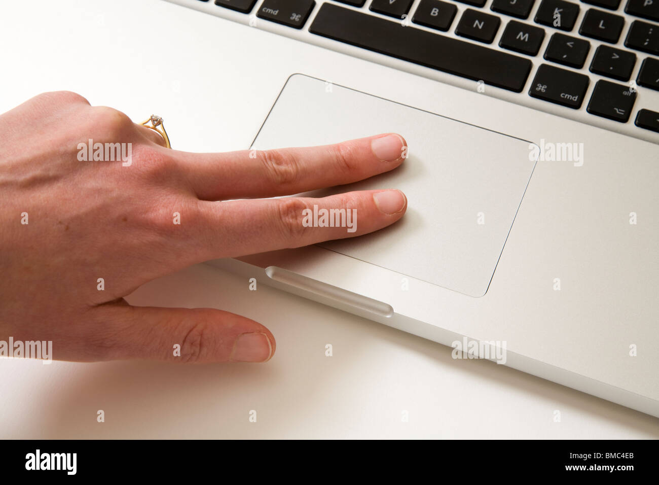 Fingers moving across an Apple Macbook Pro iBook Scrolling TrackPad