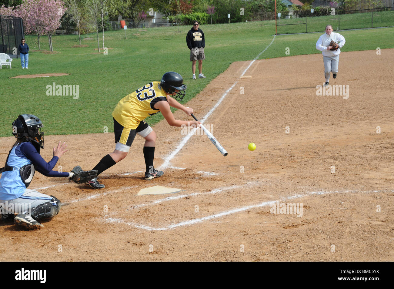 player bunts the ball in a high school softball game Stock Photo