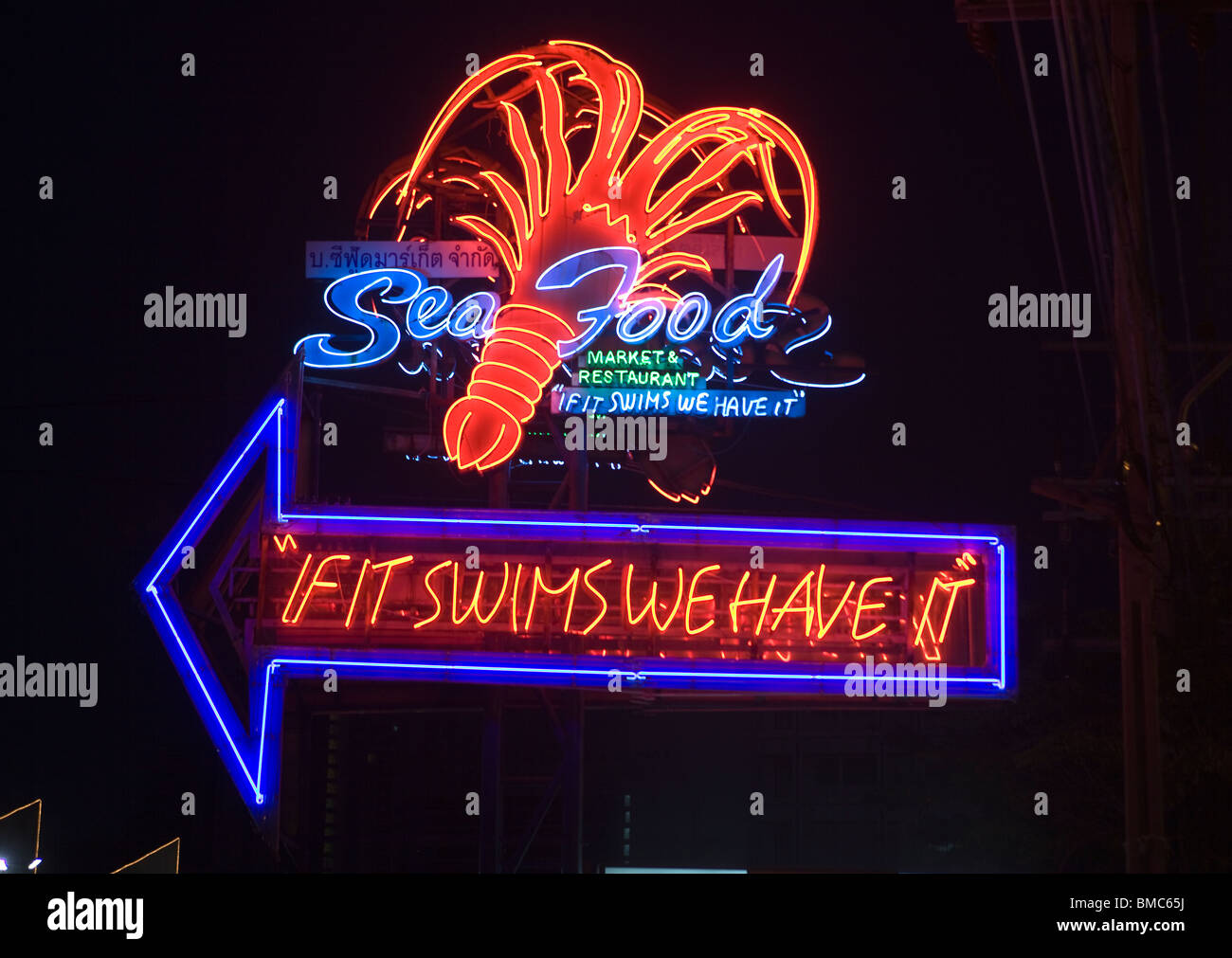 'If It Swims We Have It' Neon Sign outside Seafood Market Restaurant Sukhumvit  Bangkok Thailand Stock Photo