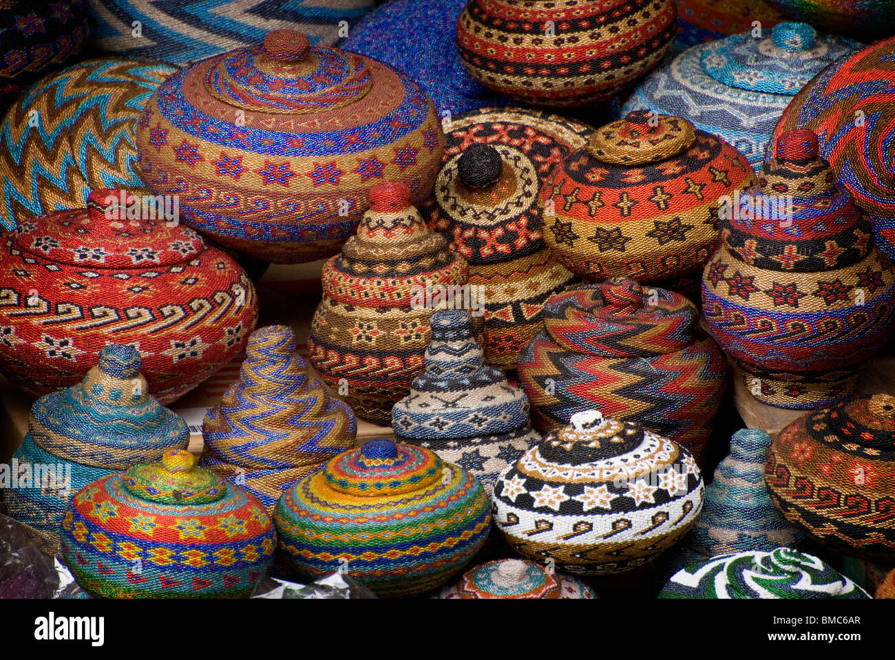 At the Ubud, Bali, public market there is a variety of art and handicrafts available for sale. These are colorful beaded baskets Stock Photo