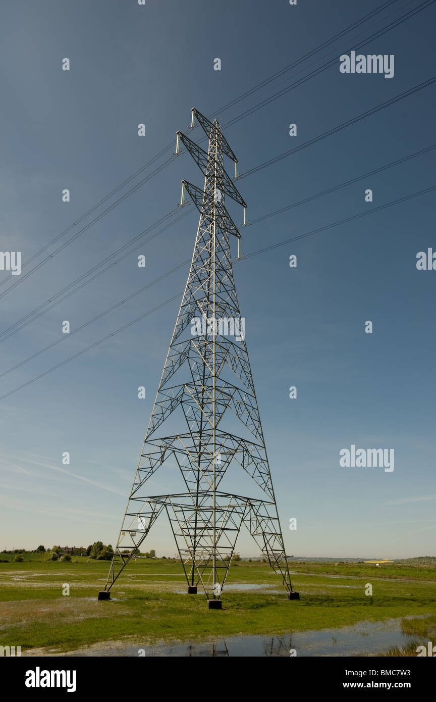 An electricity pylon sits against a blue sky Stock Photo - Alamy