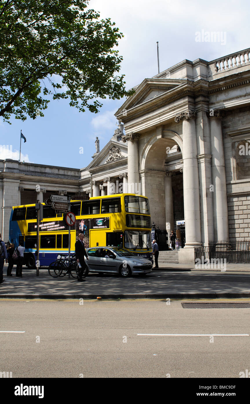 Yellow and Blue painted Dublin bus outside The Bank of Ireland building city centre Dublin Ireland Stock Photo