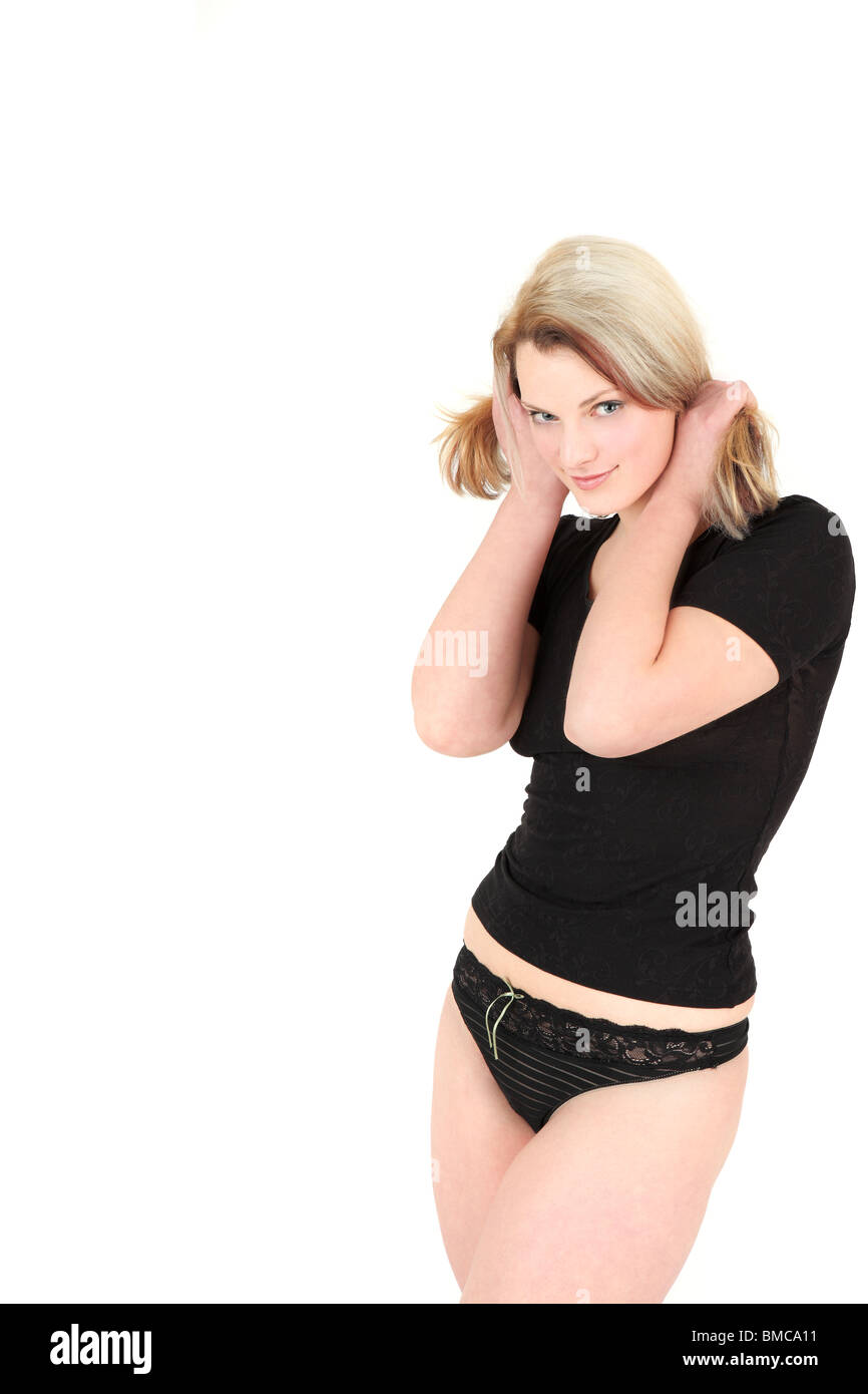 Portrait of young woman in black underwear holding hair in pigtails, studio  shot Stock Photo - Alamy