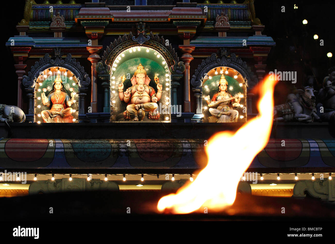 A puja flame in front of the entrance of a Hindu temple at Batu Caves, Malaysia Stock Photo