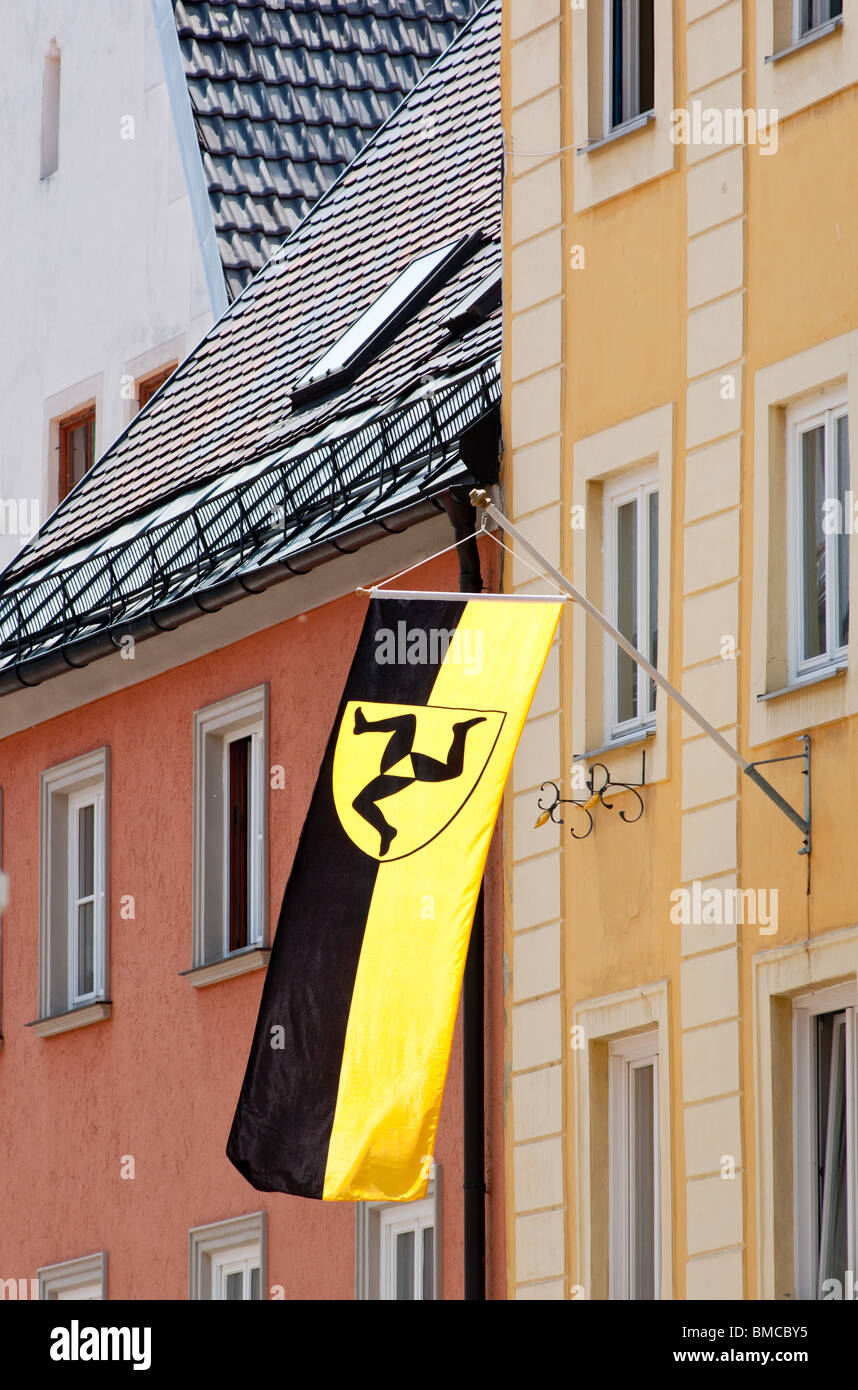 A glag with Fussen's coat of arms waving proudly from a shop front in the town. Romantic road, Bavaria, Germany. Stock Photo