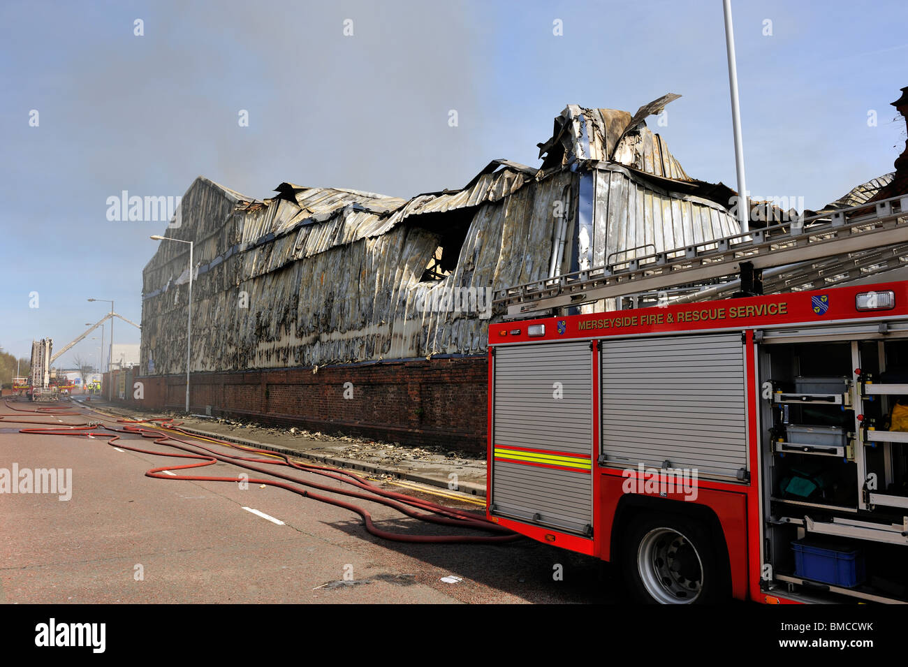 Damping down at large factory Fire UK Stock Photo