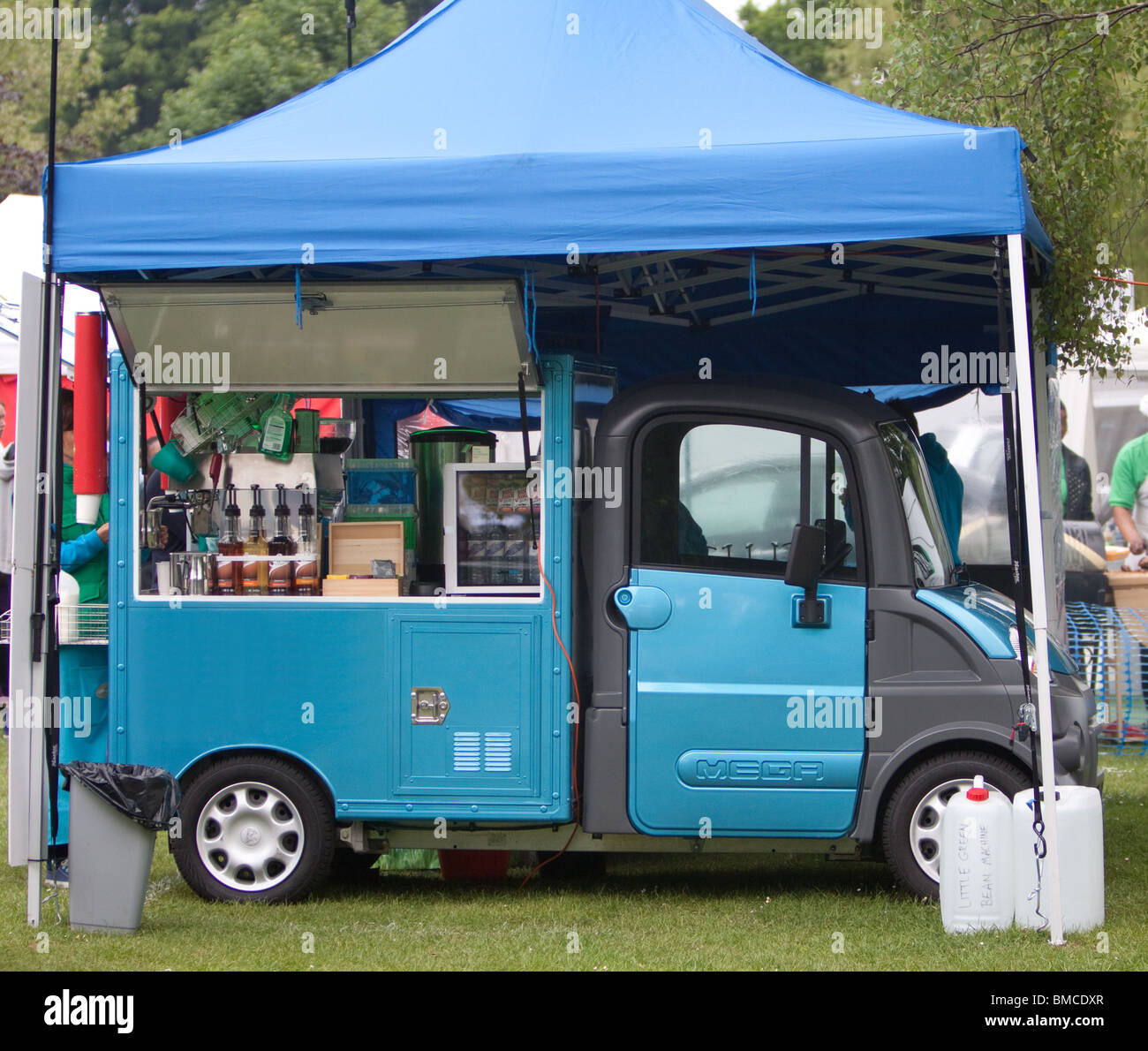 Catering van under a gazebo in the park Stock Photo