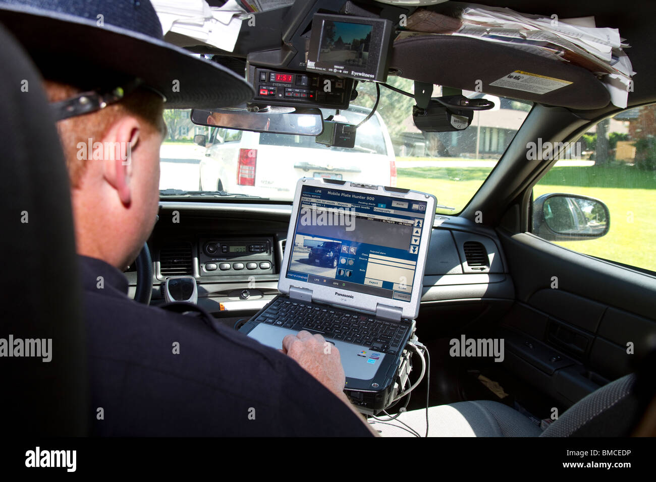 Nebraska State Trooper using laptop computer in cruiser to read output