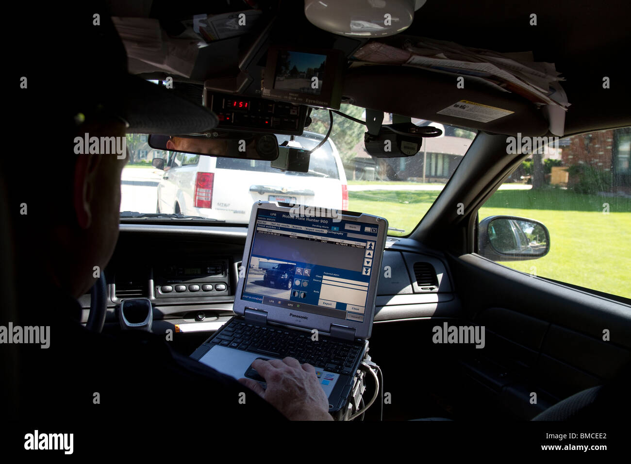 Nebraska State Trooper using laptop computer in cruiser to read output
