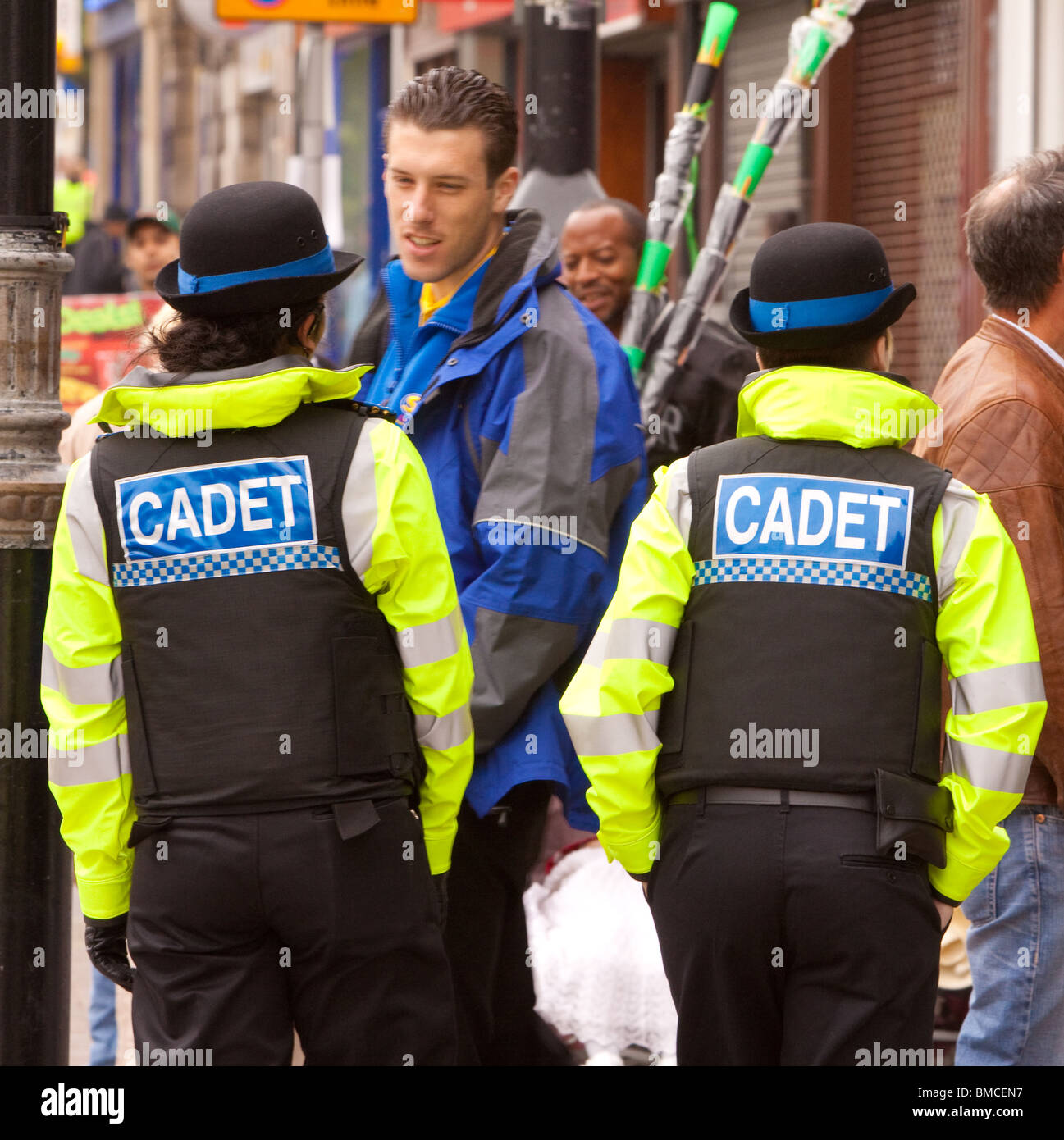 Two Police cadets talking to a member of the public Stock Photo