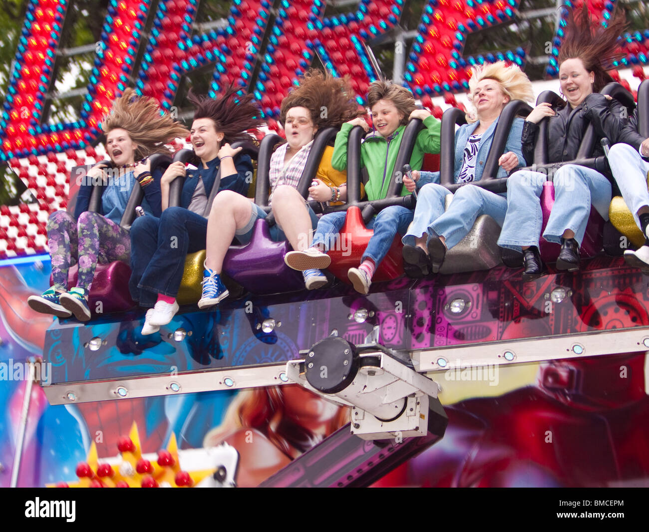 Six women screaming on a fairground ride Stock Photo