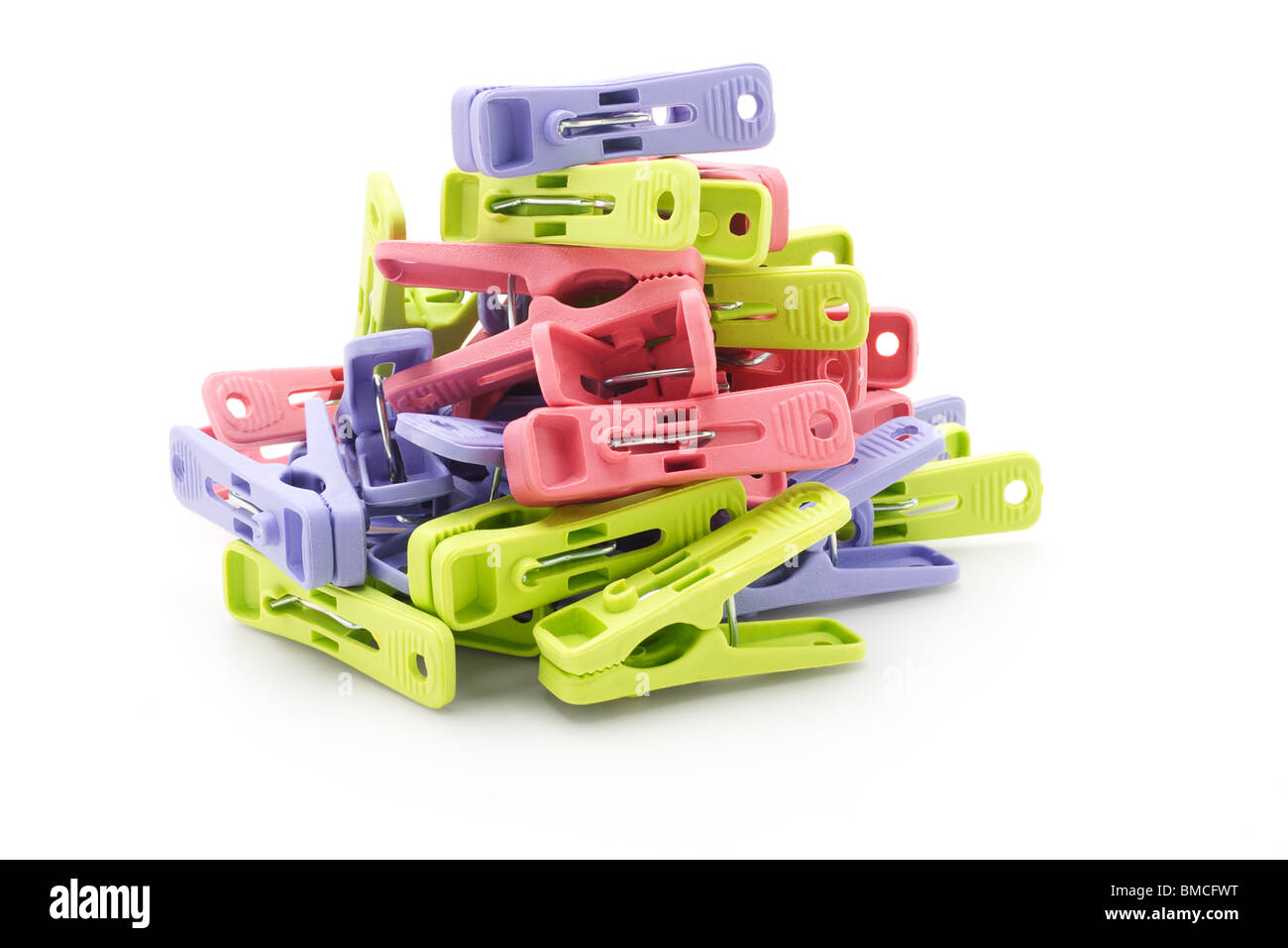 Pile of colorful plastic pegs on white background Stock Photo