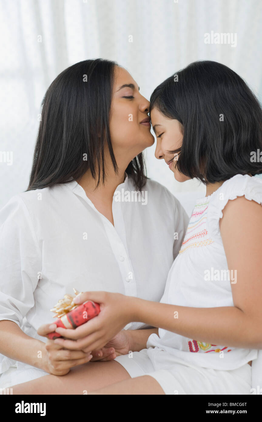 Girl giving a present to her mother Stock Photo