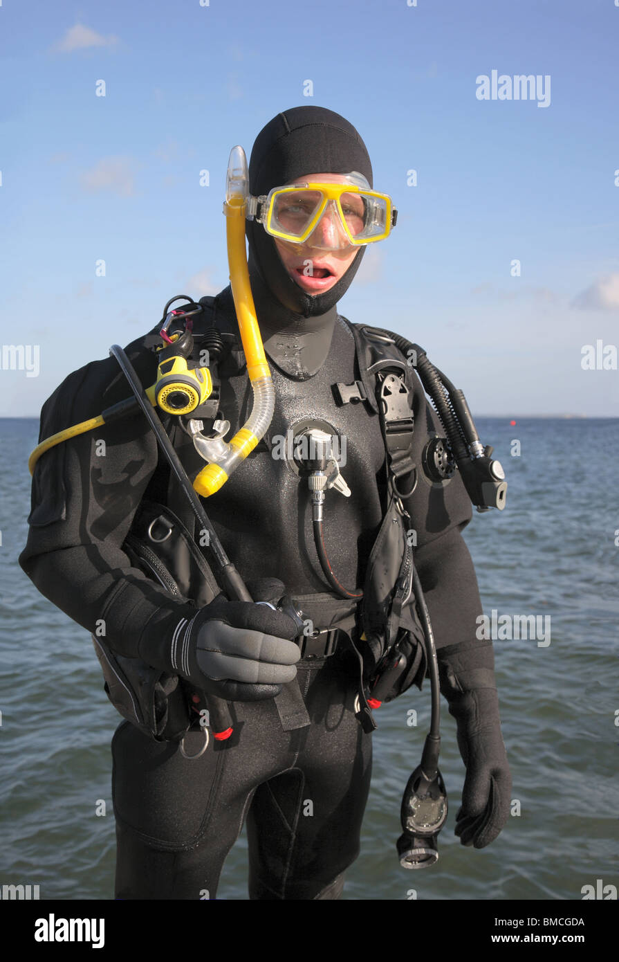 Scuba diver ready for a dive into the sea one sunny autumn day. Stock Photo