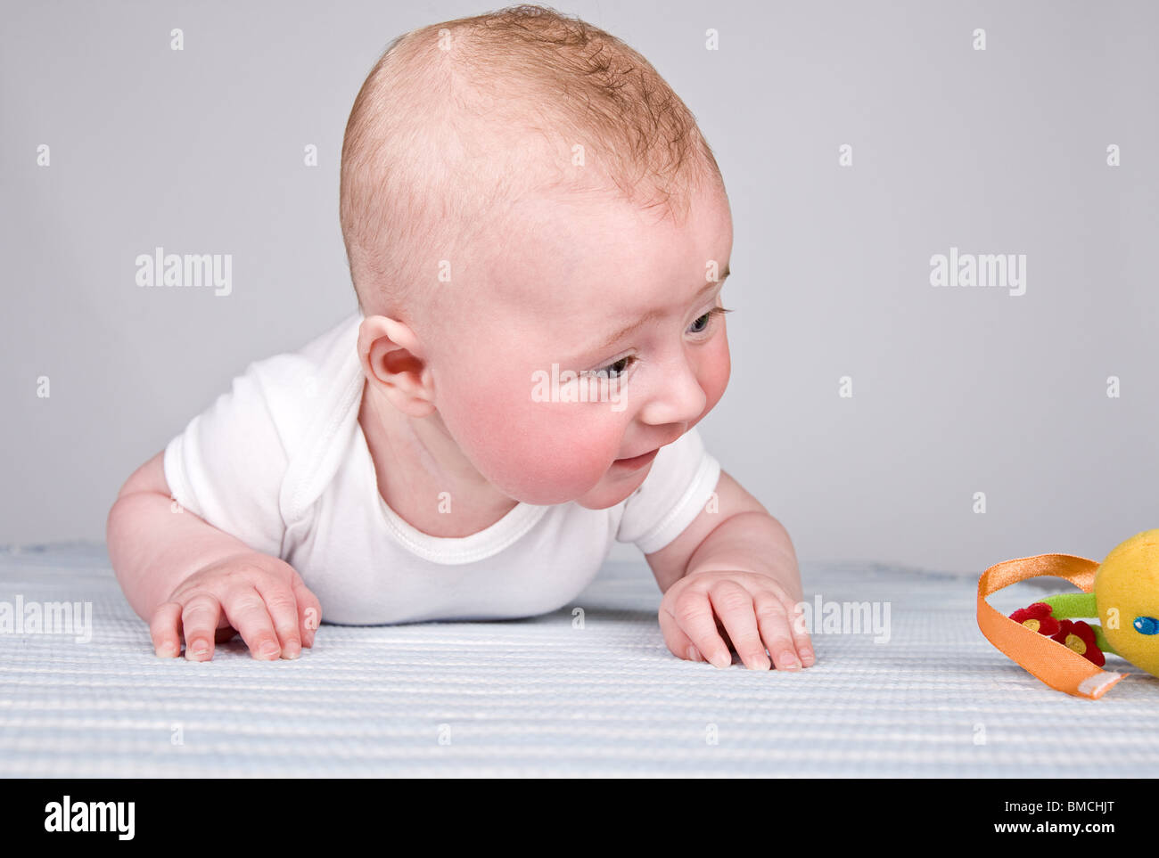 Four Month Old Baby Boy Looking at his Toy Stock Photo