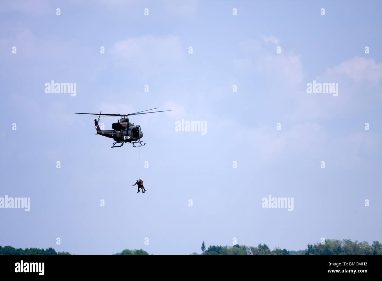 Helicopter pulling up the injured man Stock Photo Alamy
