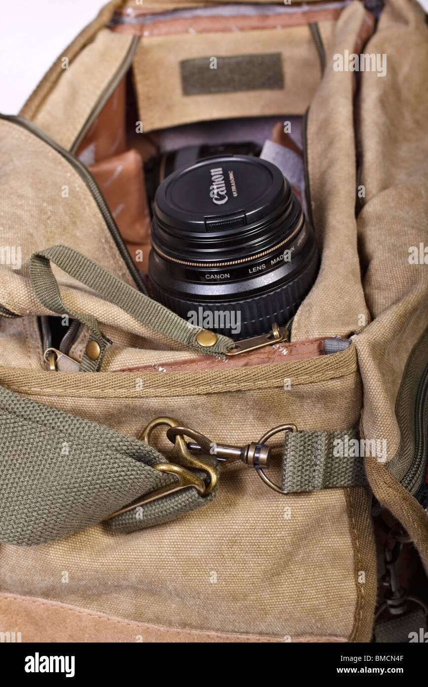 Open canvas camera bag showing camera lens. Stock Photo