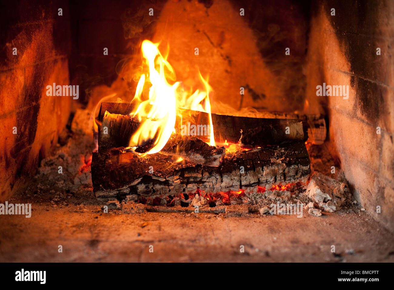 Fireplace with burning logs Stock Photo