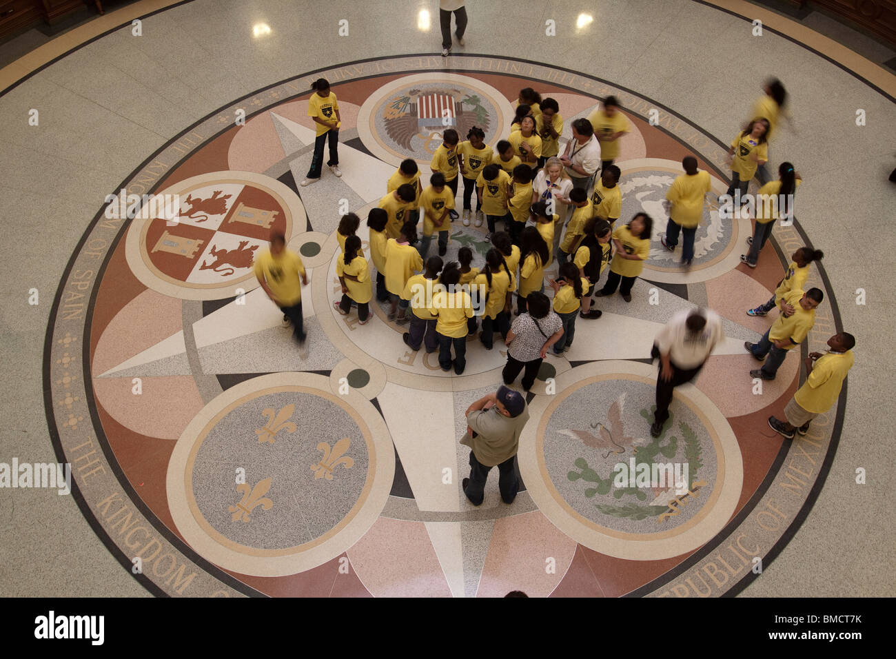 School children looking at middle seal on floor of Texas state capitol building rotunda in Austin Stock Photo