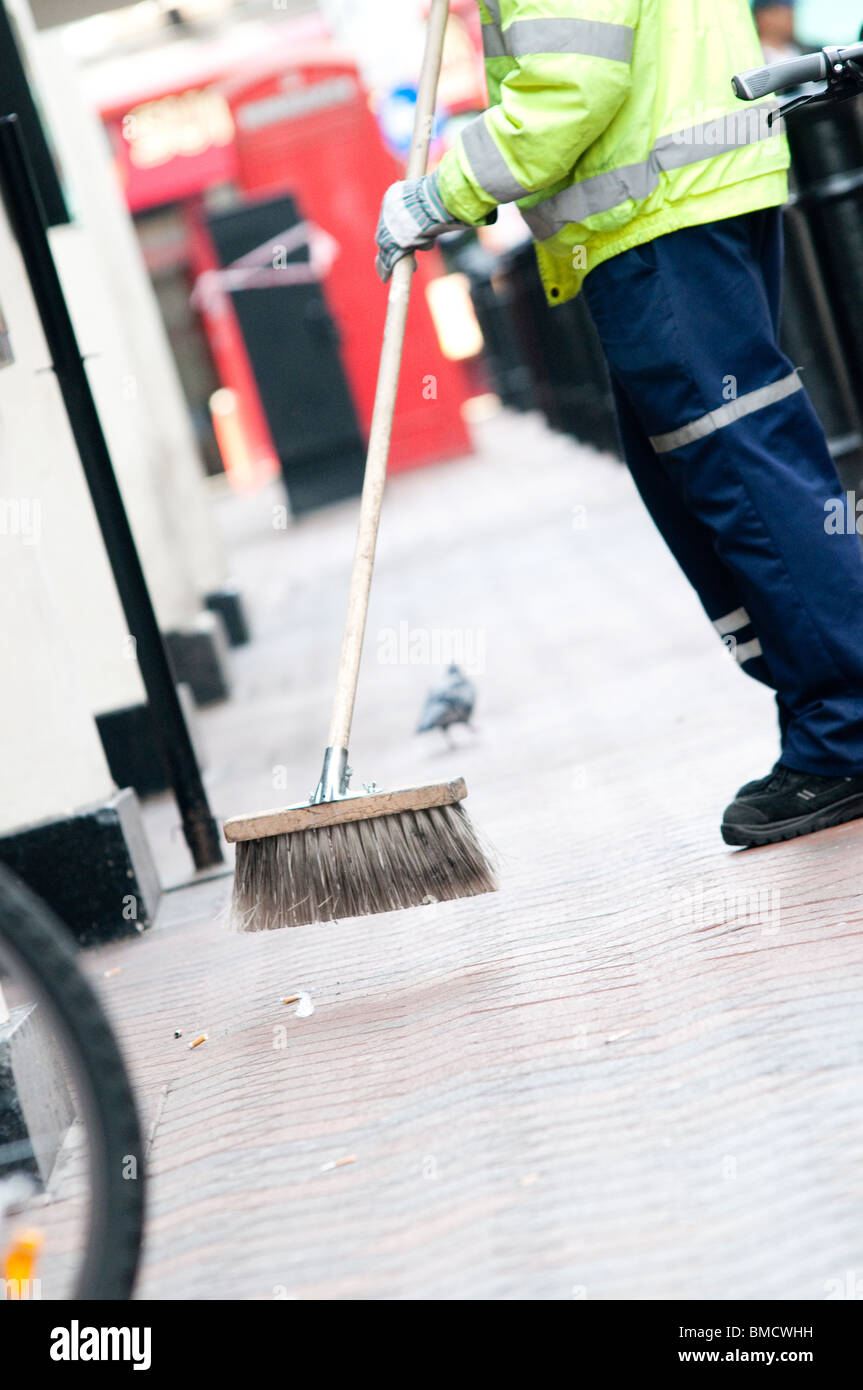 council worker sweeping pavement Stock Photo Alamy