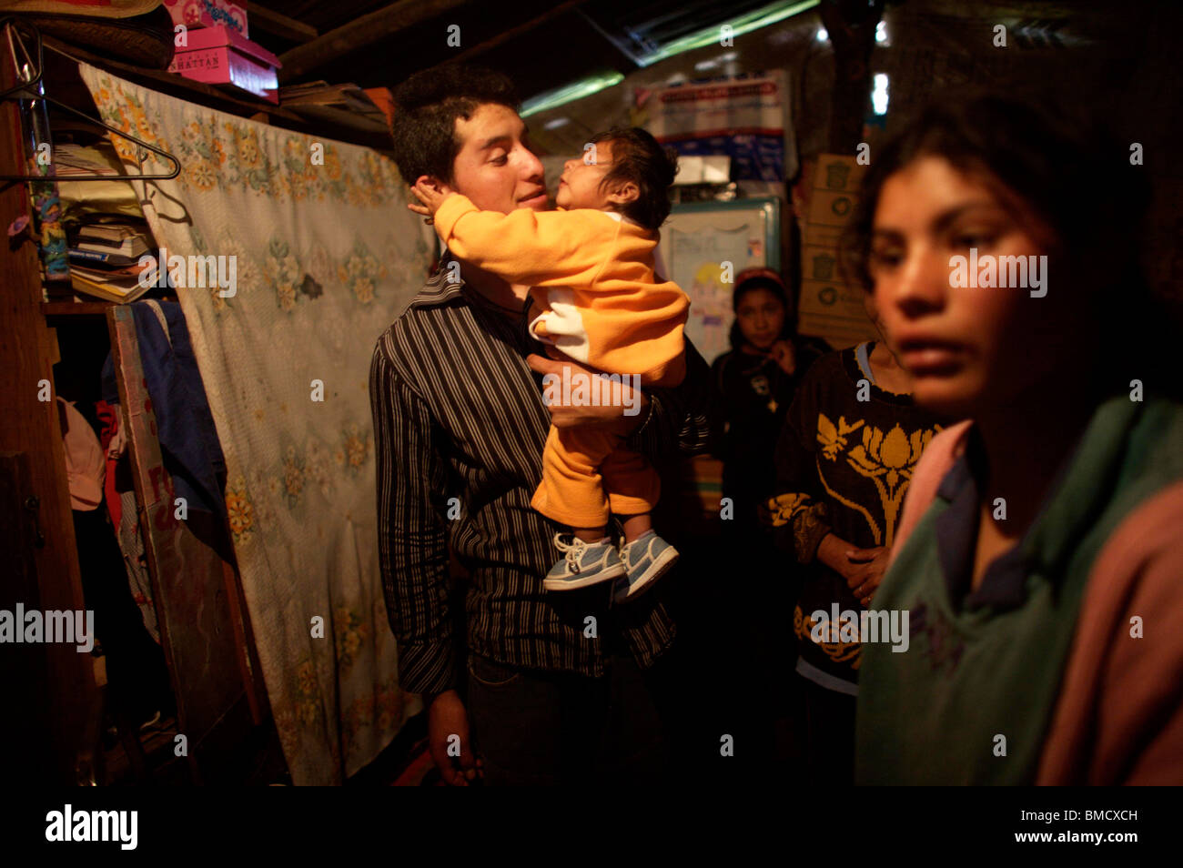 Oneyearold Alondra Viveros lies in her father's arms in her mother's