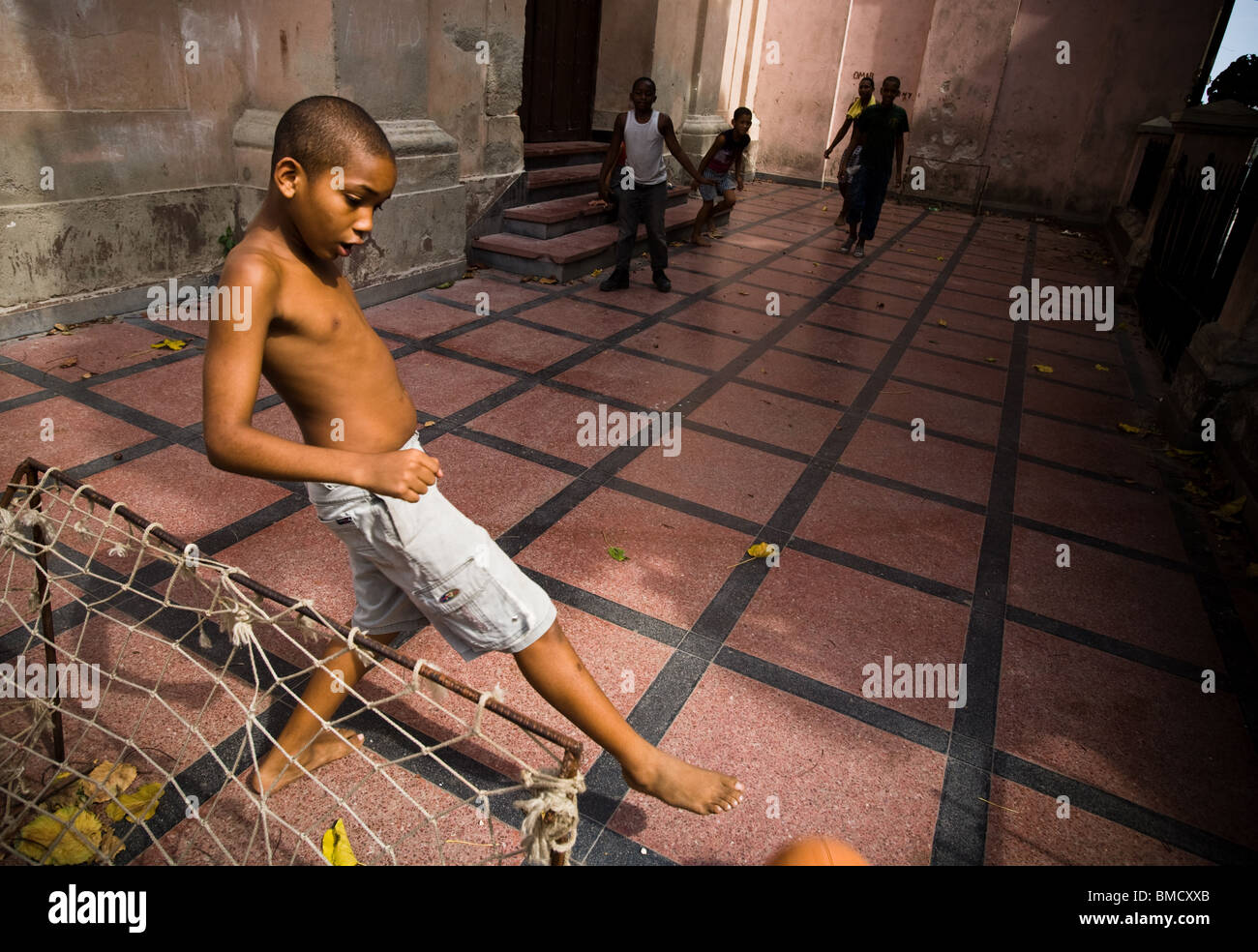 Boys play football in the courtyard of a church in Santiago, Cuba on Wednesday July 9, 2008. Stock Photo
