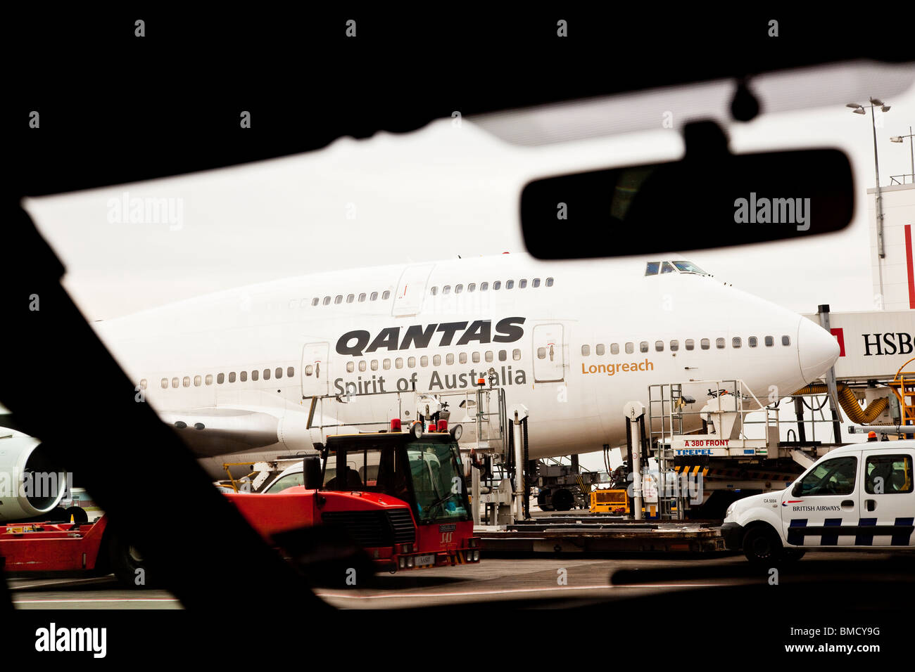 A Qantas Airways Boeing 747-400 stands a gate at Heathrow Airport London Stock Photo