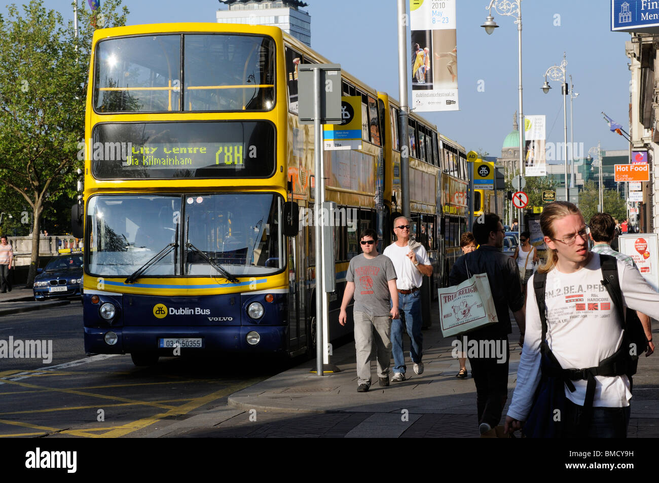 Yellow and Blue painted Dublin buses on Aston Quay in Dublin Ireland