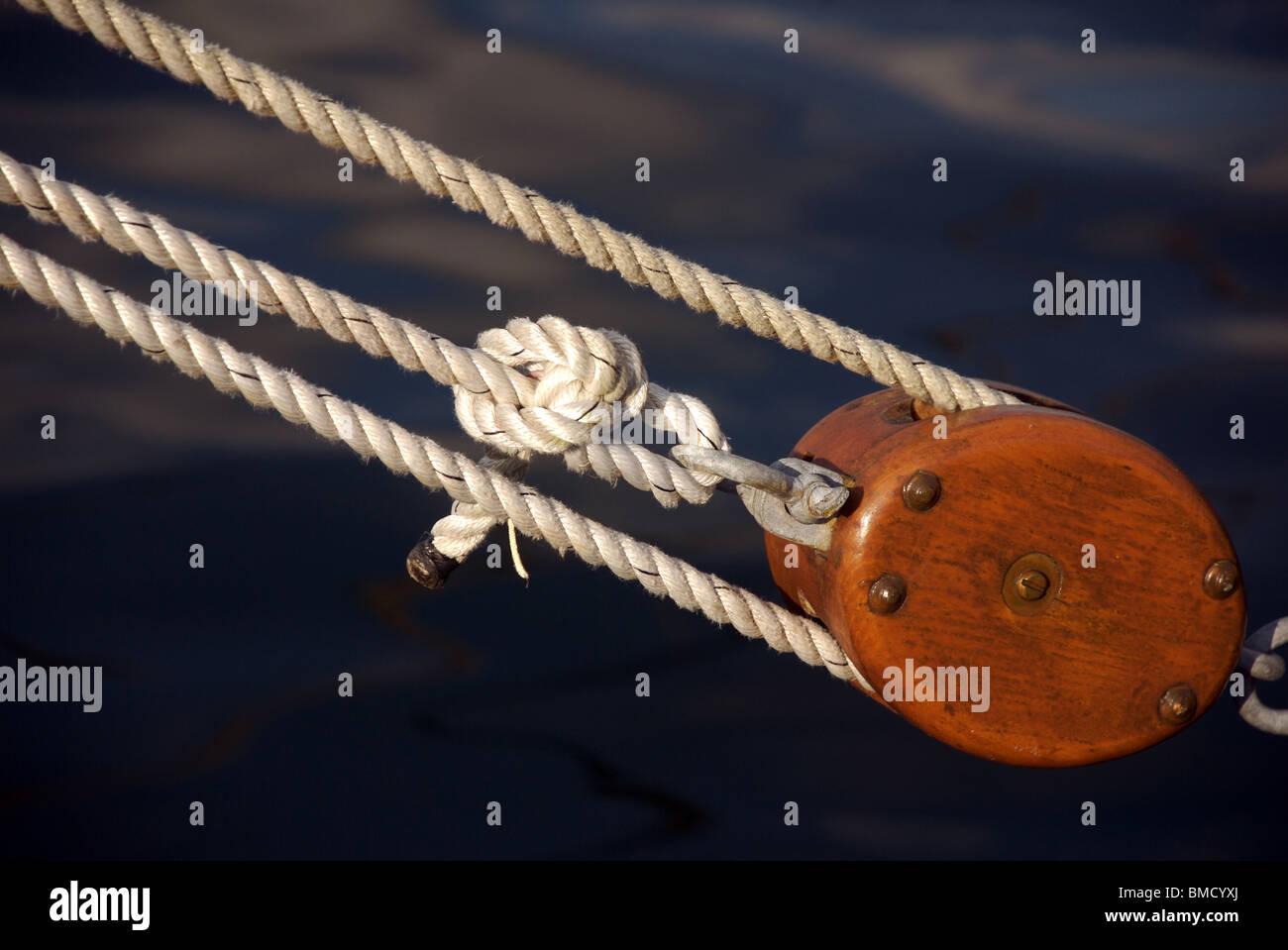 Detail of wooden block and tackle rigging on traditional ship during