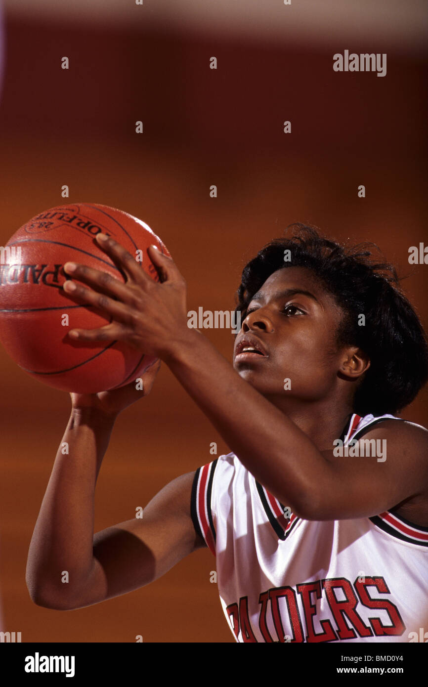 Female High School basketball player in action shooting a free throw