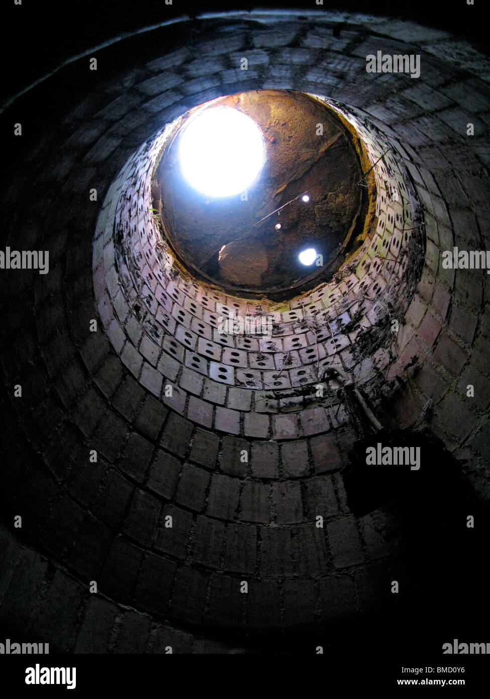 Looking up at  brick manhole from underground. Stock Photo
